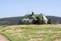 Masarykova chata, wooden cottage in mountains on the hill, springtime, green grass and blue sky Royalty Free Stock Photo