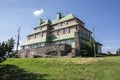 Masarykova chata, wooden cottage in mountains on the hill, springtime, green grass and blue sky Royalty Free Stock Photo