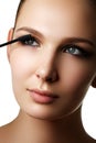 Mascara applying closeup, long lashes. Mascara brush. Eyelashes Royalty Free Stock Photo