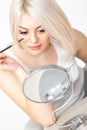 Mascara Applying. Woman applying mascara on Eyelashes. Eye Makeup Royalty Free Stock Photo