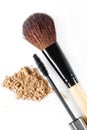 Mascara, beige powder for face and makeup brush on white background Royalty Free Stock Photo