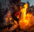 Mascaraed People jumping cross bonfires in an ancient tradition of Carnival in Vila Boa de OusilhÃ£o. Royalty Free Stock Photo