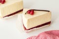 Mascarpone cheesecake with red currant and chocolate strip, serving slices.