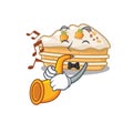 Mascot design concept of carrot cake playing a trumpet