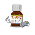 Mascot design style of antibiotic bottle gamer playing with controller