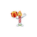 Mascot of red stripes candle character up a gift
