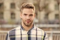 Masculine appearance. Handsome man unshaven face and stylish hair. Caucasian man urban background. Bearded man in casual