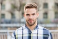 Masculine appearance. Handsome man unshaven face and stylish hair. Caucasian man urban background. Bearded man in casual Royalty Free Stock Photo