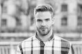 Masculine appearance. Handsome man unshaven face and stylish hair. Caucasian man urban background. Bearded man in casual Royalty Free Stock Photo