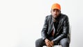 Masculine fashion man leather jacket orange cap Royalty Free Stock Photo