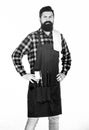 Masculine hobby. Bearded hipster wear apron for barbecue. Roasting and grilling food. Man hold cooking utensils barbecue Royalty Free Stock Photo