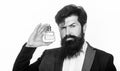 Masculine perfume, bearded man in a suit. Male holding up bottle of perfume. Closeup portrait. Black and white