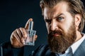 Masculine perfume. Male fragrance and perfumery, cosmetics. Bearded man holding up bottle of perfume. Fashion cologne Royalty Free Stock Photo