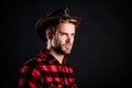 Masculinity and brutality concept. Adopt cowboy mannerisms as a fashion pose. Man unshaven cowboy black background Royalty Free Stock Photo