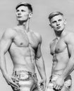Masculinity concept. Men twins brothers muscular guys sky background. Men strong muscular athlete bodybuilder