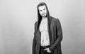 Masculinity and confidence. Man well groomed handsome hooded clothes. Unconventional but masculine look. Brute