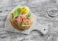 Mashed avocado sandwich with smoked salmon and fried quail egg. A delicious breakfast or snack. Royalty Free Stock Photo