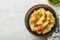 Mashed boiled potatoes. Bacon mashed potatoes with green onion, pepper and cheddar cheese in bowl on light old wooden backgrounds