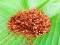 Mashed dried red hot chili on green banana leaf, Food ingredient for spicy recipe.