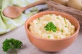 Mashed potato in bowl and fresh potatoes in basket