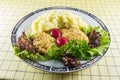 Mashed potato with chicken chops, radish, onion and salad on the kitchen`s table