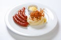 Mashed potato and roasted sausage or bratwurst on white plate Royalty Free Stock Photo