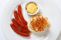 Mashed potato and roasted sausage or bratwurst on white plate Royalty Free Stock Photo