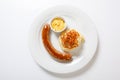 Mashed potato and roasted sausage or bratwurst on white plate Royalty Free Stock Photo