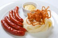 Mashed potato and roasted sausage or bratwurst on white plate Royalty Free Stock Photo
