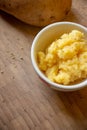 Mashed potato served in small white bowl.