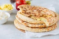 Mashed potato and sheep cheese filling flatbread on a white stone background. Royalty Free Stock Photo