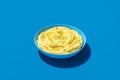 Mashed potatoes bowl minimalist on a blue background Royalty Free Stock Photo