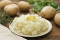 Mashed potatoes with butter and fresh white potatoes on background, wooden table. Healthy food for kids, dinner Royalty Free Stock Photo