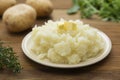 Mashed potatoes with butter and fresh white potatoes on background, wooden table. Healthy food for kids, dinner Royalty Free Stock Photo