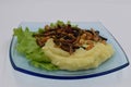 Mashed potatoes with fried insects and lettuce