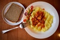 Mashed potatoes with fried meat, onions and carrots.