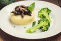 Mashed potatoes with mushrooms and boiled broccoli sauce. Wooden background. Top view. Close-up Royalty Free Stock Photo