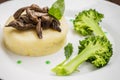 Mashed potatoes with mushrooms and boiled broccoli sauce. Wooden background. Top view. Close-up Royalty Free Stock Photo