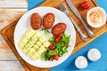 Mashed potatoes sprinkled with greens, juicy meat cutlets Royalty Free Stock Photo