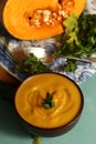 Mashed pumpkin soup with parsley and raw piece Royalty Free Stock Photo