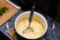 Mashing potatoes with a hand in a pot - sometimes called smashed potatoes - Shallow focus
