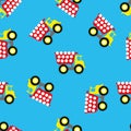 Seamless pattern with toy tractor on blue background. Vector illustration.