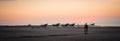 Masirah Island, Oman, December 31, 2019: beautiful panoramic image of a loving couple taking a walk on the beach with boats Royalty Free Stock Photo