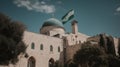 Masjid Al-Aqsa standing tall in the heart of the Old City of Jerusalem, the Palestinian flag gently waving in the breeze, a serene