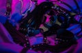 mask of a bdsm demon and leather accessories for bdsm games on a dark background in neon light Royalty Free Stock Photo