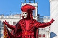 Mask in beautiful red costume at Venice Carnival Royalty Free Stock Photo