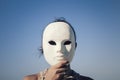 Mask enigmatic girl blue sky