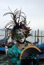 A mask with folding fan at the Venice carnival