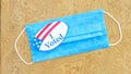 Mask with I voted sticker on table Royalty Free Stock Photo