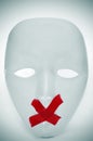 Mask with its mouth shut with red tape